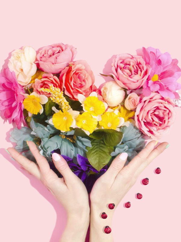 Heart of flowers held in two hands